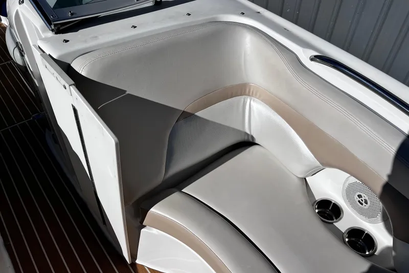 Slide: The Image of 2005 Chaparral Sunesta 254 boat interior seating with cup holders and speaker. - 13
