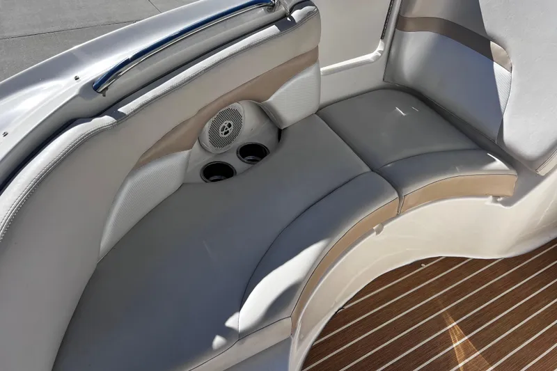 Slide: The Image of 2005 Chaparral Sunesta 254 boat interior with cushioned seating and cup holders. - 14