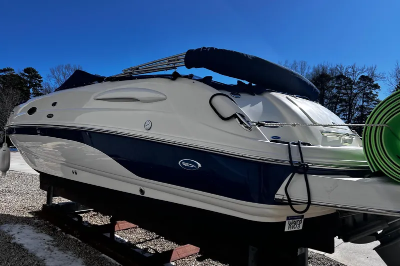 Slide: The Image of 2005 Chaparral Sunesta 254 boat on trailer under clear blue sky. - 4