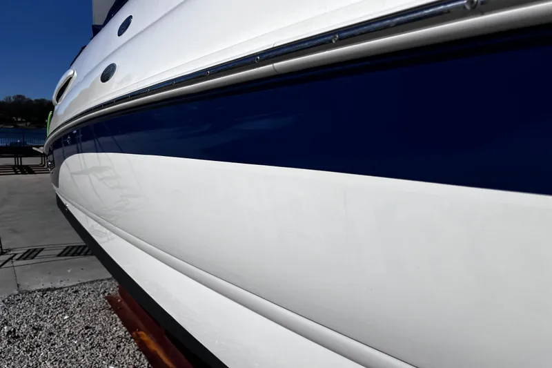 Slide: The Image of 2005 Chaparral Sunesta 254 boat hull with sleek blue and white design. - 6