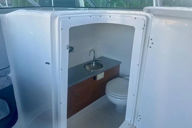 Slide: The Image of 2019 Hurricane SunDeck 2690 OB boat interior with sink and toilet. - 4