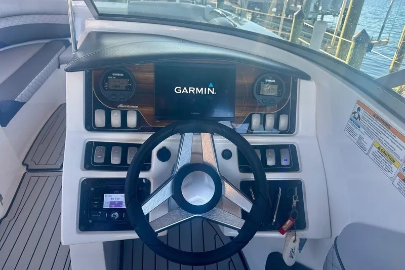 Slide: The Image of 2019 Hurricane SunDeck 2690 OB boat dashboard with Garmin display and Yamaha controls. - 6