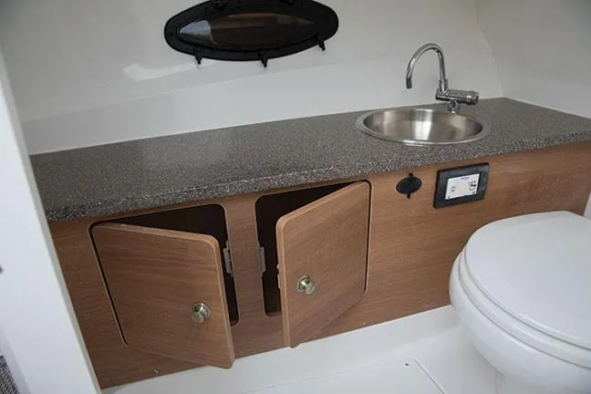 Slide: The Image of Manufacturer Provided Image: 2019 Hurricane SunDeck 2690 OB boat bathroom with sink, countertop, and storage cabinets. - 9