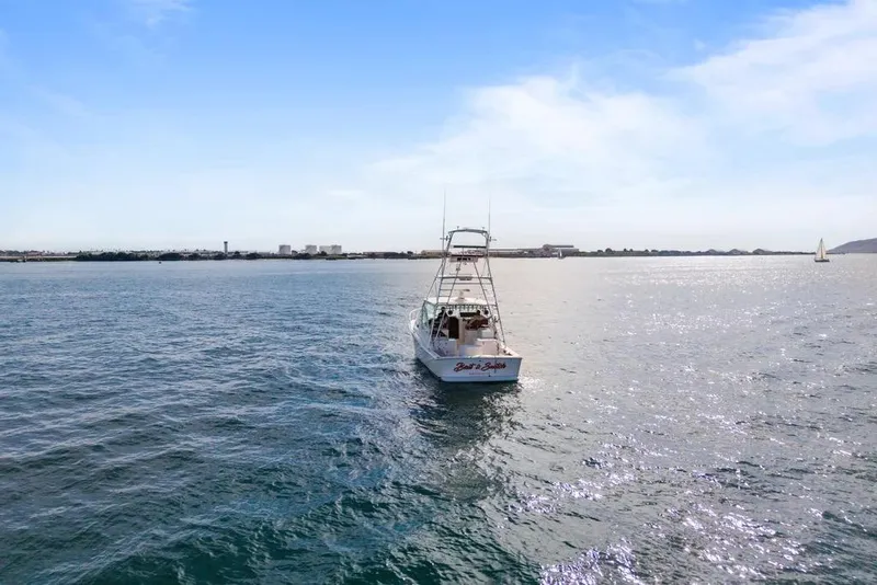 Slide: The Image of 2005 Cabo 35 Express boat on open water under clear blue sky. - 58