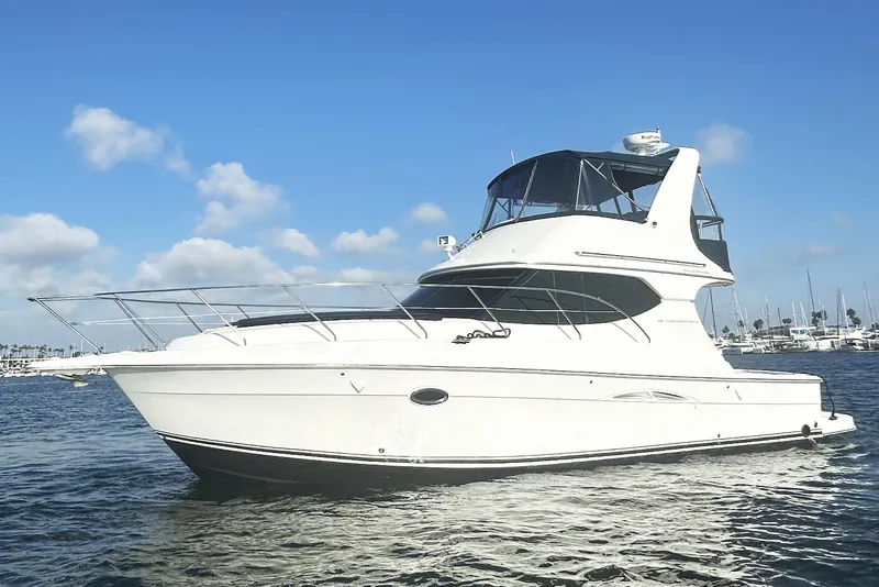 The Image of 2008 Silverton 36 Convertible yacht on calm water under blue sky. - 0