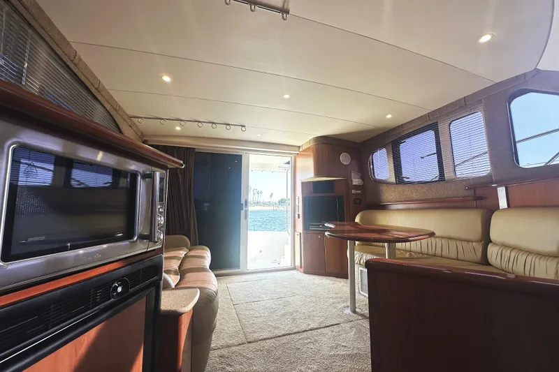 Slide: The Image of Interior of 2008 Silverton 36 Convertible yacht with luxurious seating and modern amenities. - 12