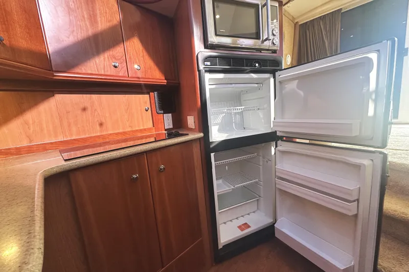 Slide: The Image of 2008 Silverton 36 Convertible yacht kitchen with open fridge and microwave. - 14