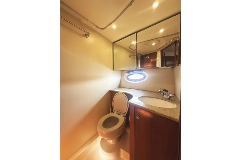 Slide: The Image of 2008 Silverton 36 Convertible yacht bathroom with modern fixtures and porthole window. - 25