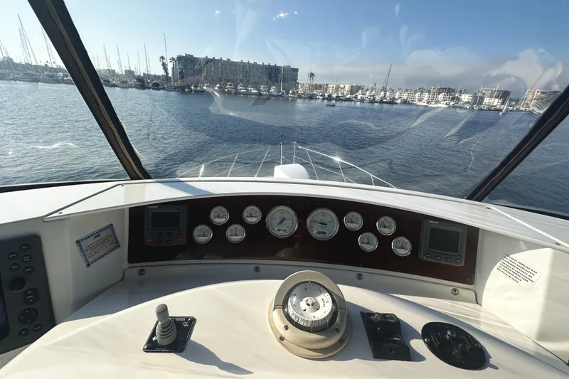 Slide: The Image of Helm view of 2008 Silverton 36 Convertible yacht in marina setting. - 29