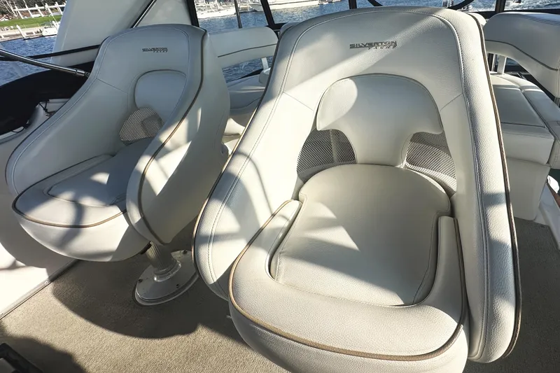 Slide: The Image of Luxury seating on 2008 Silverton 36 Convertible yacht, featuring plush white upholstery. - 33