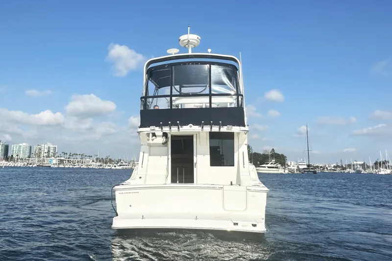 Slide: The Image of 2008 Silverton 36 Convertible yacht on calm water, clear sky background. - 4