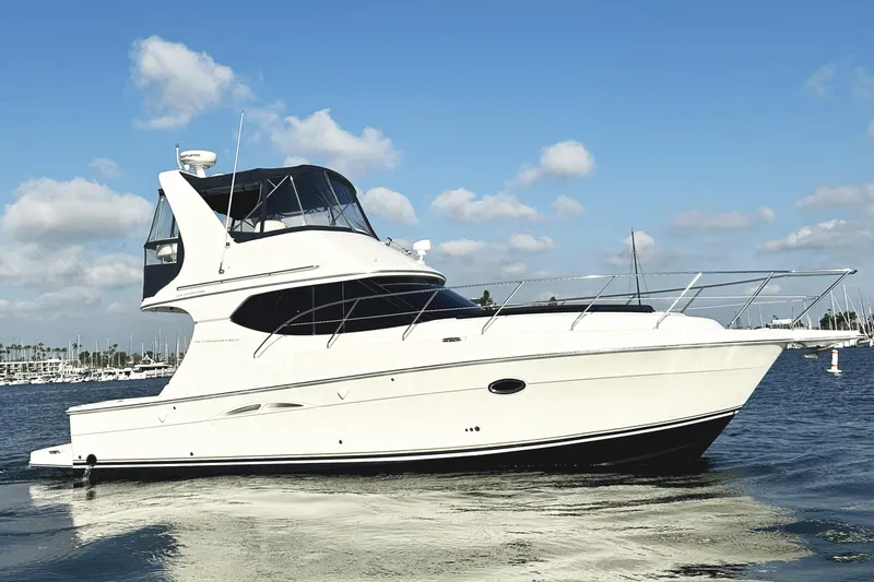 Slide: The Image of 2008 Silverton 36 Convertible yacht on calm water under blue sky. - 6