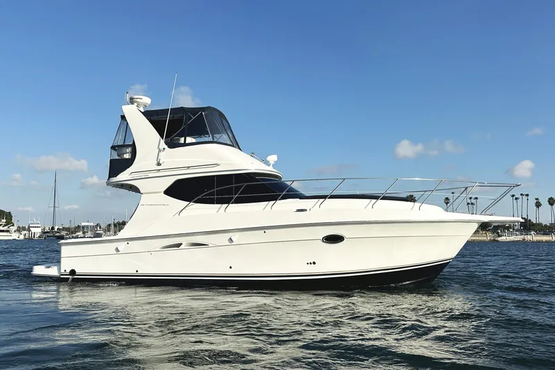 Slide: The Image of 2008 Silverton 36 Convertible yacht on calm water under clear blue sky. - 7