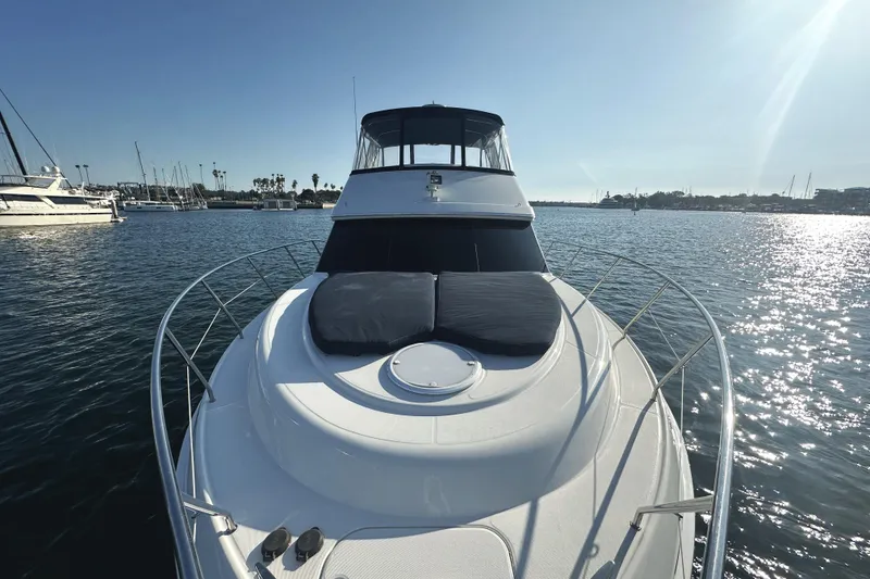 Slide: The Image of 2008 Silverton 36 Convertible yacht on calm water, sunny day, marina in background. - 9