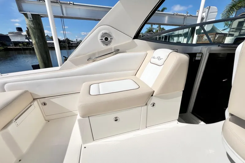 Slide: The Image of 2012 Sea Ray 310 Sundancer boat interior with beige seating and storage compartments. - 16