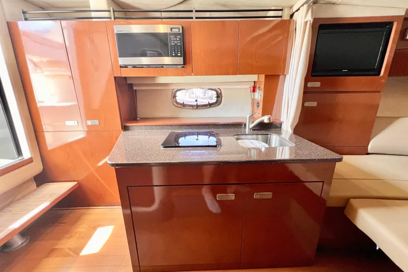 Slide: The Image of Luxurious 2012 Sea Ray 310 Sundancer yacht interior with modern kitchen amenities. - 23