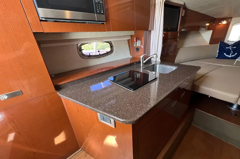 Slide: The Image of Luxurious interior of 2012 Sea Ray 310 Sundancer yacht with modern kitchen amenities. - 24