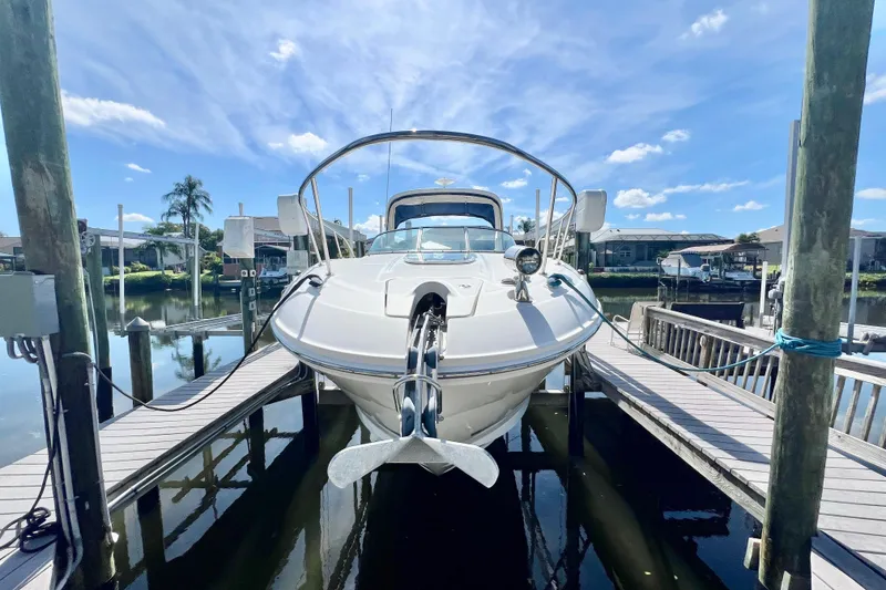 Slide: The Image of 2012 Sea Ray 310 Sundancer docked under a clear blue sky. - 6