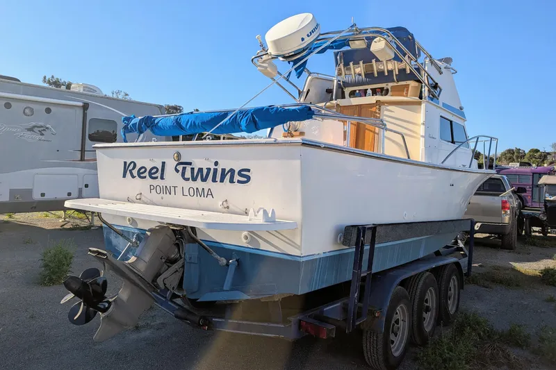 Slide: The Image of 1989 Blackman Billfisher 26 boat on trailer, named "Reel Twins," located in Point Loma. - 12