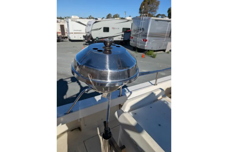 Slide: The Image of Stainless steel grill on 1989 Blackman Billfisher 26 boat, parked near RVs. - 15