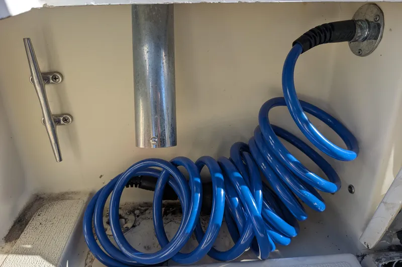 Slide: The Image of Blue coiled hose in 1989 Blackman Billfisher 26 boat compartment. - 26