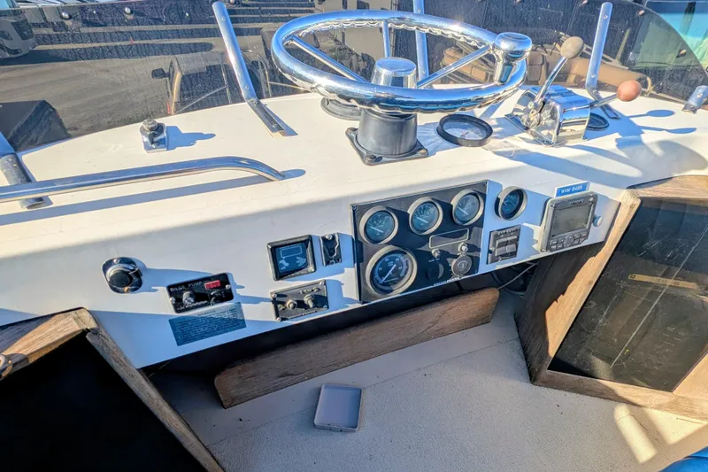 Slide: The Image of 1989 Blackman Billfisher 26 boat dashboard with steering wheel and control gauges. - 36