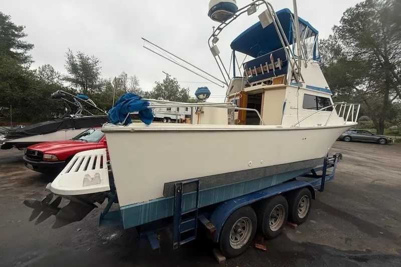 Slide: The Image of 1989 Blackman Billfisher 26 boat on trailer, parked outdoors, overcast sky. - 5