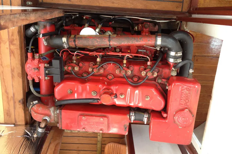 Slide: The Image of Red engine of a 1958 Atkins Sun Flower 22 boat, showcasing detailed mechanical components. - 11
