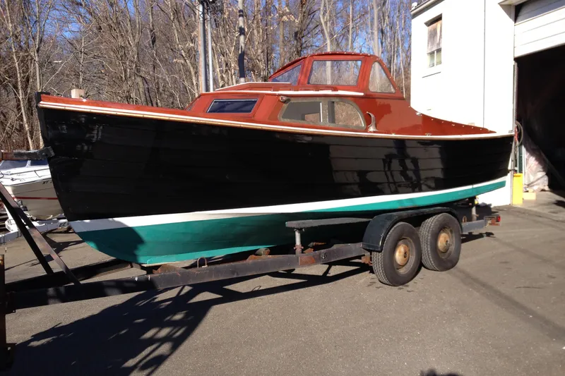 Slide: The Image of 1958 Atkins Sun Flower 22 boat on trailer, black and teal hull, parked outdoors. - 8