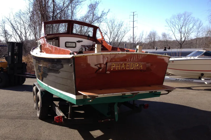 Slide: The Image of 1958 Atkins Sun Flower 22 boat named "Phaedra" on trailer, outdoors in sunny setting. - 9
