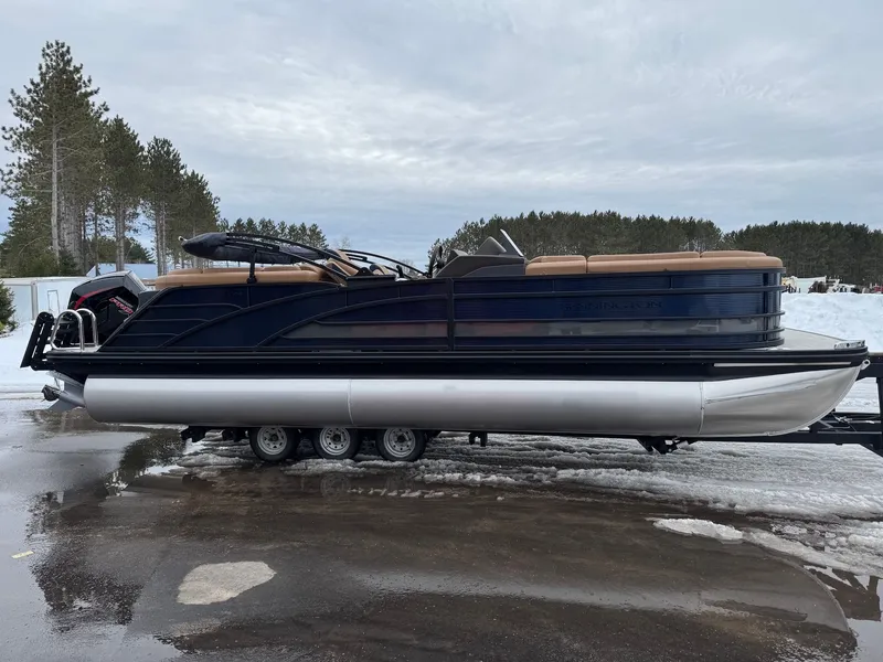 Slide: The Image of 2026 Bennington 23RFB ESP TRI pontoon boat on trailer outdoors. - 12