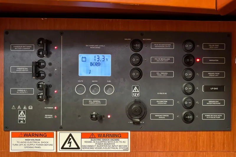 Slide: The Image of Electrical control panel on a 2015 Beneteau Oceanis 37 sailboat, displaying voltage and warnings. - 15