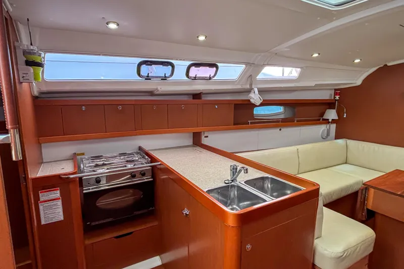 Slide: The Image of Interior of 2015 Beneteau Oceanis 37 yacht with kitchen and seating area. - 17