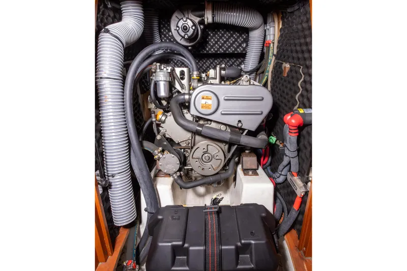 Slide: The Image of Engine compartment of a 2015 Beneteau Oceanis 37 sailboat, showcasing detailed mechanical components. - 19