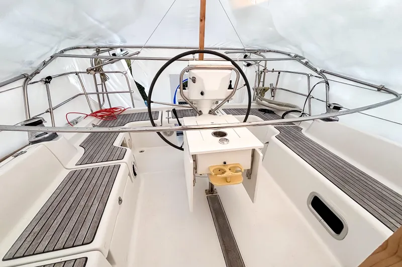 Slide: The Image of Cockpit of 2015 Beneteau Oceanis 37 sailboat with steering wheel and seating. - 4