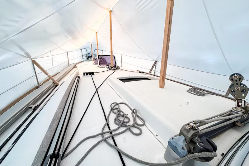 Slide: The Image of Beneteau Oceanis 37 sailboat deck under protective cover, showcasing rigging and ropes, 2015 model. - 6