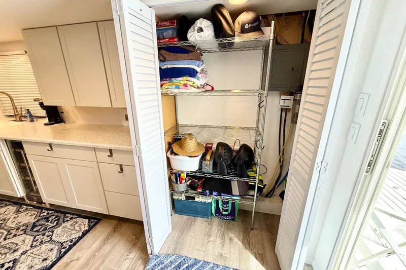 Slide: The Image of Organized storage in 1985 Three Buoys 42 Sport Cruiser HB kitchen, featuring shelves and cabinets. - 10