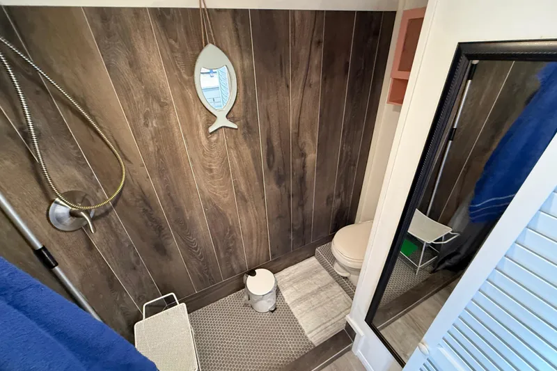 Slide: The Image of Bathroom interior of 1985 Three Buoys 42 Sport Cruiser HB with wood paneling and nautical decor. - 12