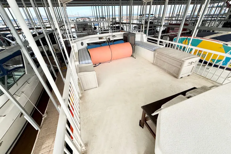 Slide: The Image of 1985 Three Buoys 42 Sport Cruiser HB docked, spacious deck, marina view. - 15