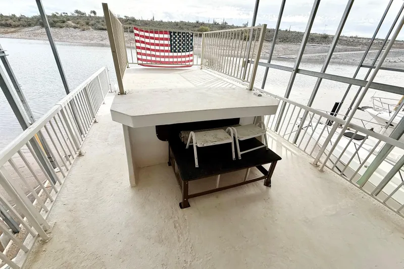 Slide: The Image of Upper deck of 1985 Three Buoys 42 Sport Cruiser HB with American flag display. - 16