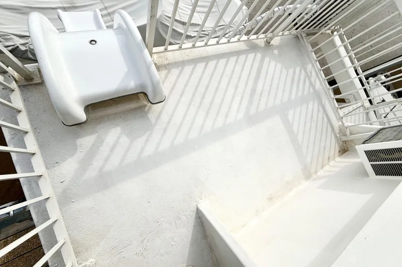 Slide: The Image of White deck area of 1985 Three Buoys 42 Sport Cruiser HB with slide and railings. - 17