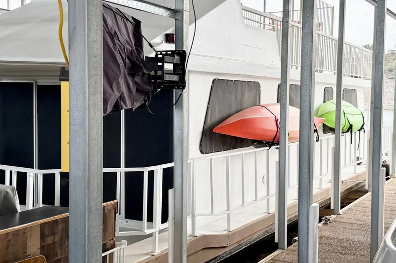 Slide: The Image of 1985 Three Buoys 42 Sport Cruiser HB with kayaks docked at marina. - 19