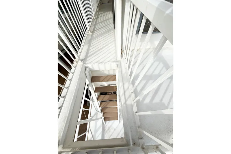 Slide: The Image of White metal staircase on a 1985 Three Buoys 42 Sport Cruiser HB boat. - 20
