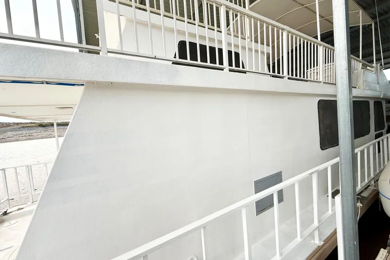 Slide: The Image of 1985 Three Buoys 42 Sport Cruiser HB, white exterior with railings, docked at marina. - 21