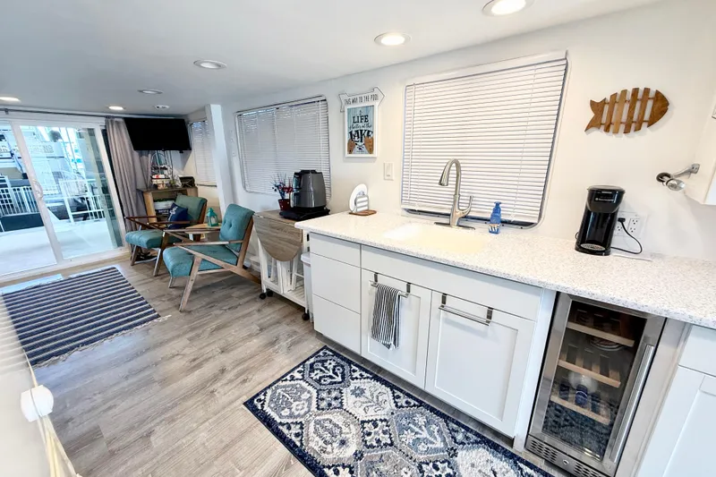 Slide: The Image of Interior of 1985 Three Buoys 42 Sport Cruiser HB with modern kitchen and cozy seating area. - 5