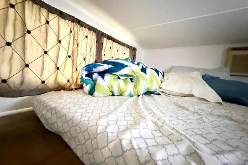 Slide: The Image of Cozy cabin bed in 1985 Three Buoys 42 Sport Cruiser HB with patterned bedding. - 8