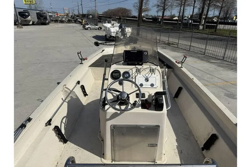 Slide: The Image of 2009 Express HD20 boat with steering console, parked outdoors. - 2
