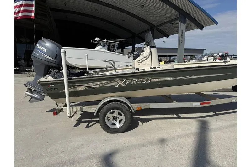 Slide: The Image of 2009 Express HD20 boat on trailer with Yamaha outboard motor, parked outdoors. - 3