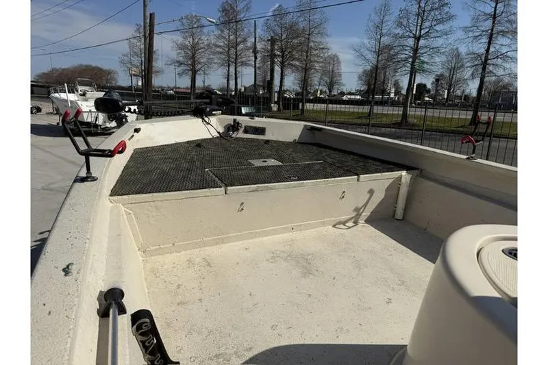 Slide: The Image of 2009 Express HD20 boat deck with fishing setup, parked outdoors. - 6