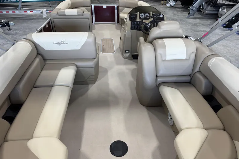 Slide: The Image of 2022 SunChaser Geneva Cruise 24 CRS pontoon boat interior with beige seating and helm. - 10